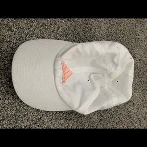 White Adidas hat, light pink writing